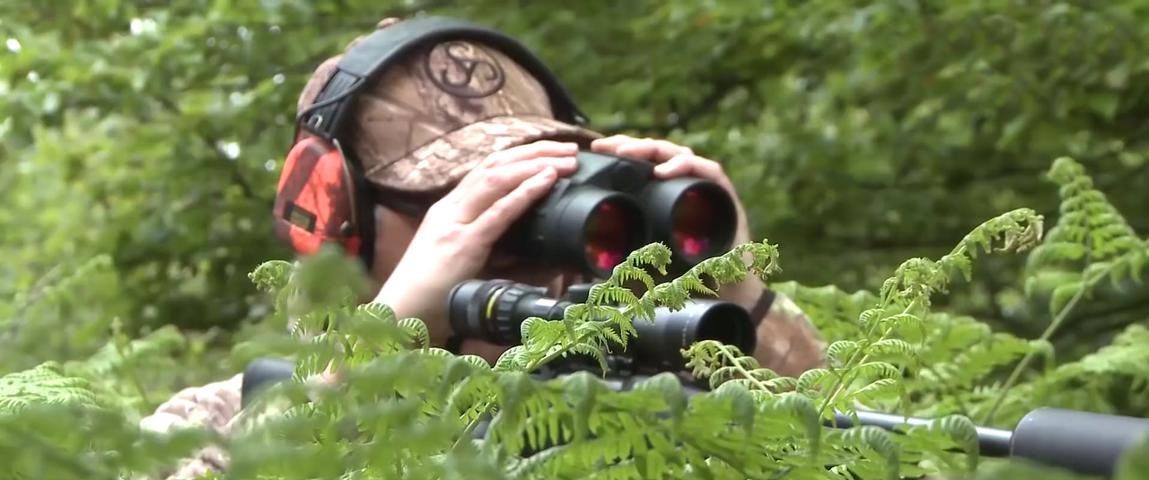 Hunter glassing for game with binoculars